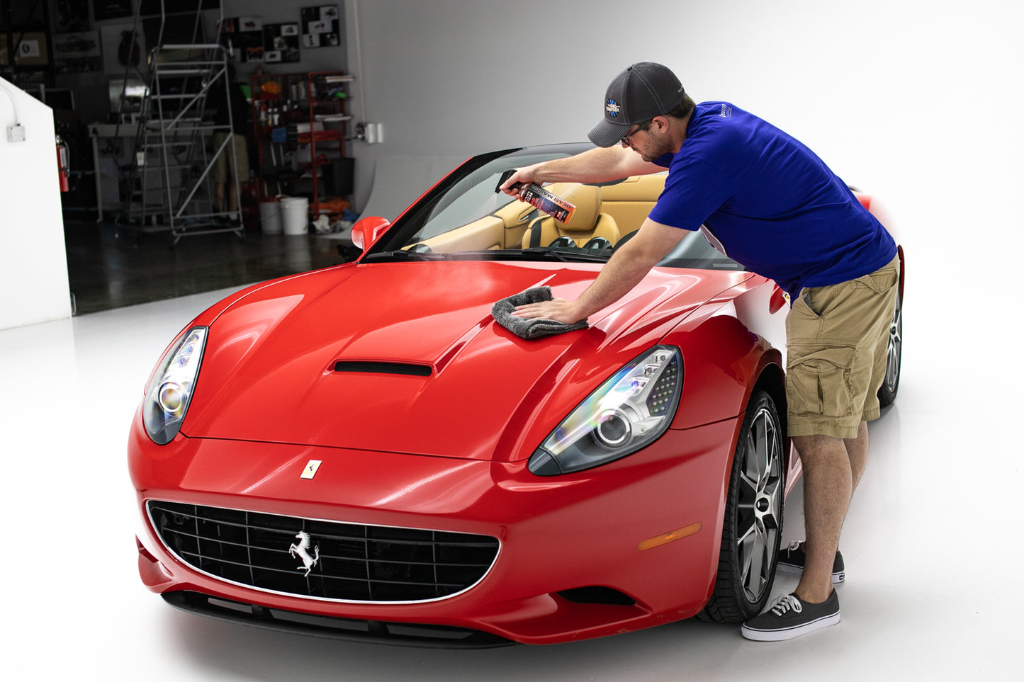 Spraying P&S Bead Maker spray sealant onto car hood with microfiber towel