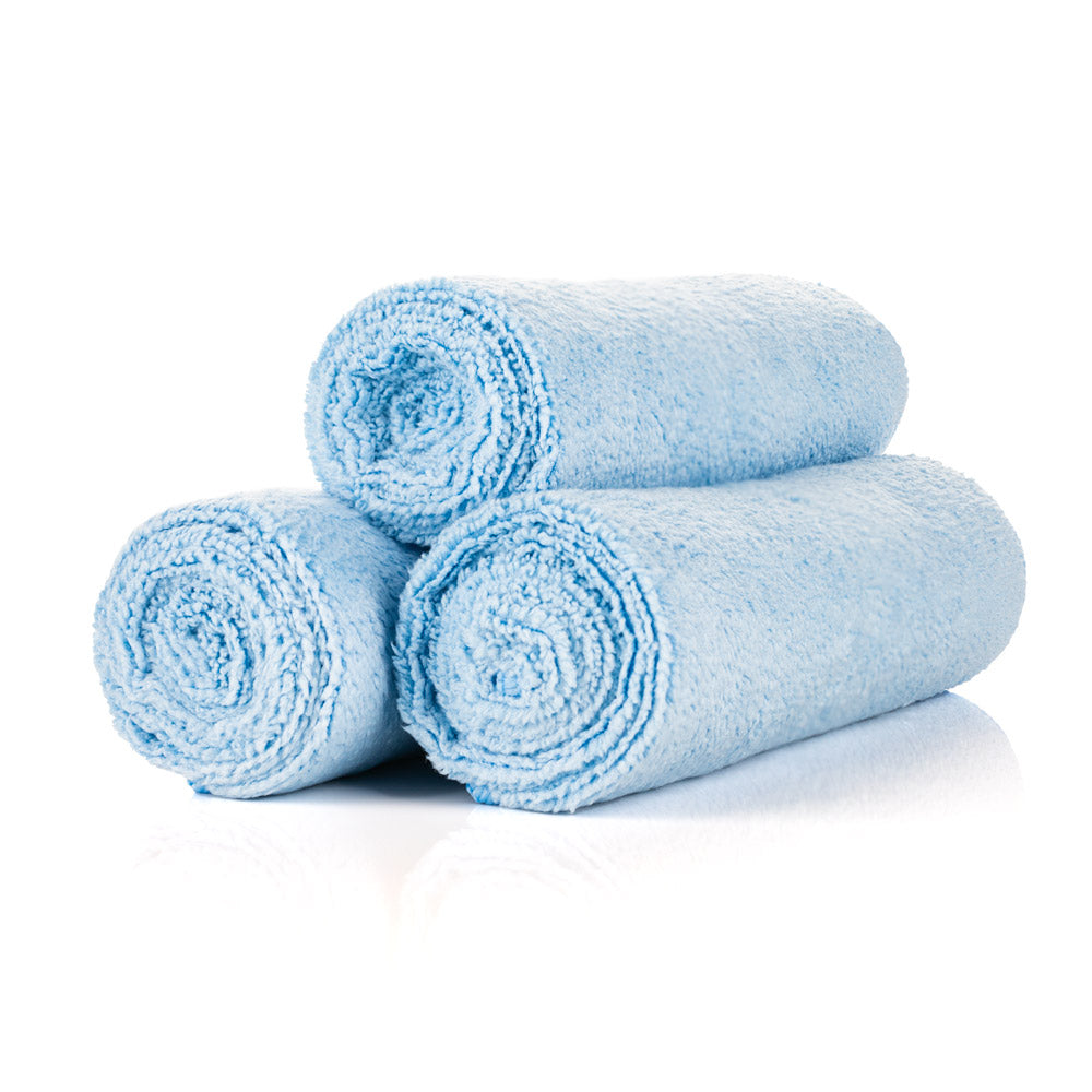 3 light blue towels rolled up